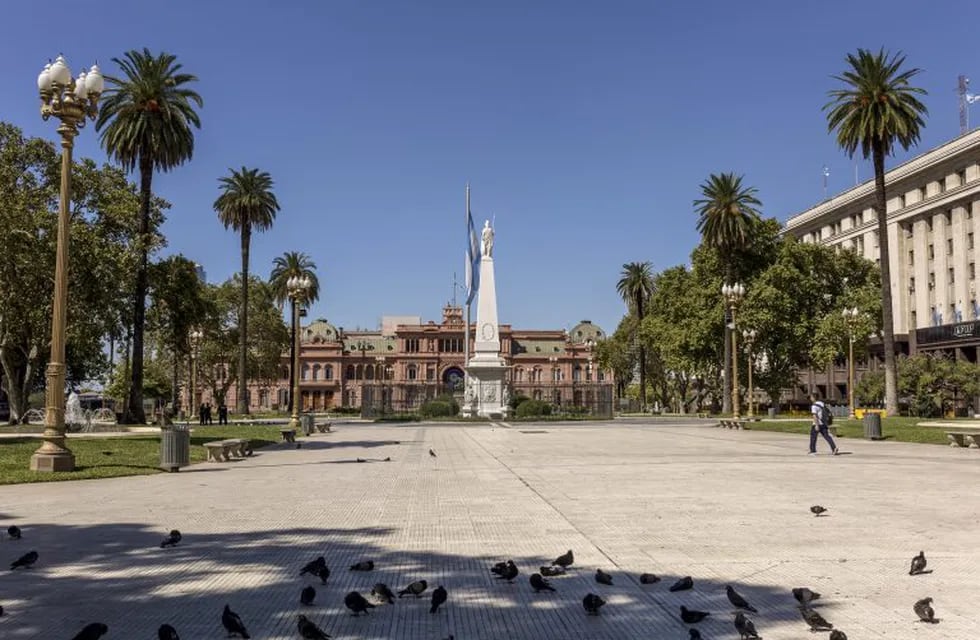 A pedestrian walks through the near deserted Plaza de Mayo in Buenos Aires, Argentina, on Friday, March 20, 2020. Argentina imposed a nationwide lockdown to stem the coronavirus pandemic, marking one of the strictest measures taken by any Latin American nation. Photographer: Sarah Pabst/Bloomberg