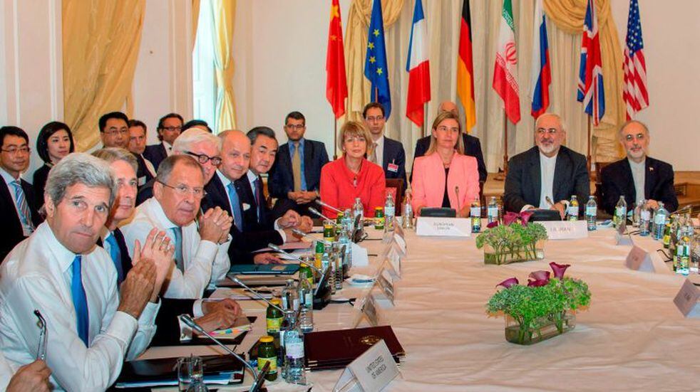 (FILES) This file photo taken on July 6, 2015 shows (L-R) then US Secretary of State John Kerry, then British Foreign Minister Philip Hammond, Russian Foreign Minister Sergey Lavrov, then German Foreign Minister Frank-Walter Steinmeier, then French Foreign Minister Laurent Fabius, China's Foreign Minister Wang Yi, EU Secretary General for the External Action Service Helga Schmid, then High Representative of the European Union for Foreign Affairs and Security Policy Federica Mogherini, Iranian Foreign Minister Mohammad Javad Zarif and Iran's ambassador to IAEA, Ali Akbar Salehi, as they meet at Palais Coburg Hotel, where the Iran nuclear talks meetings were being held, in Vienna, Austria. - The 2015 nuclear deal between Iran and world powers has been left in tatters after Tehran on January 5 2020 announced a further rollback of its commitments under the landmark accord following the US assassination of Iranian top general Qasem Soleimani. (Photo by Joe KLAMAR / AFP)