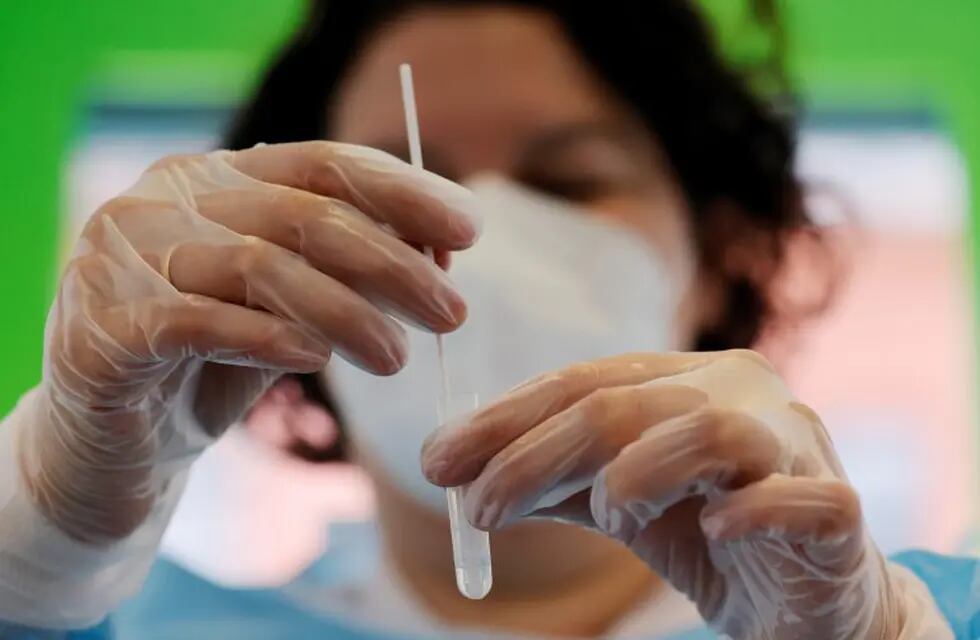A chemist performs a rapid Covid-19 antigenic test at a pharmacy in Roubaix as a second wave of the coronavirus disease sweeps France, October 28, 2020.  REUTERS/Pascal Rossignol