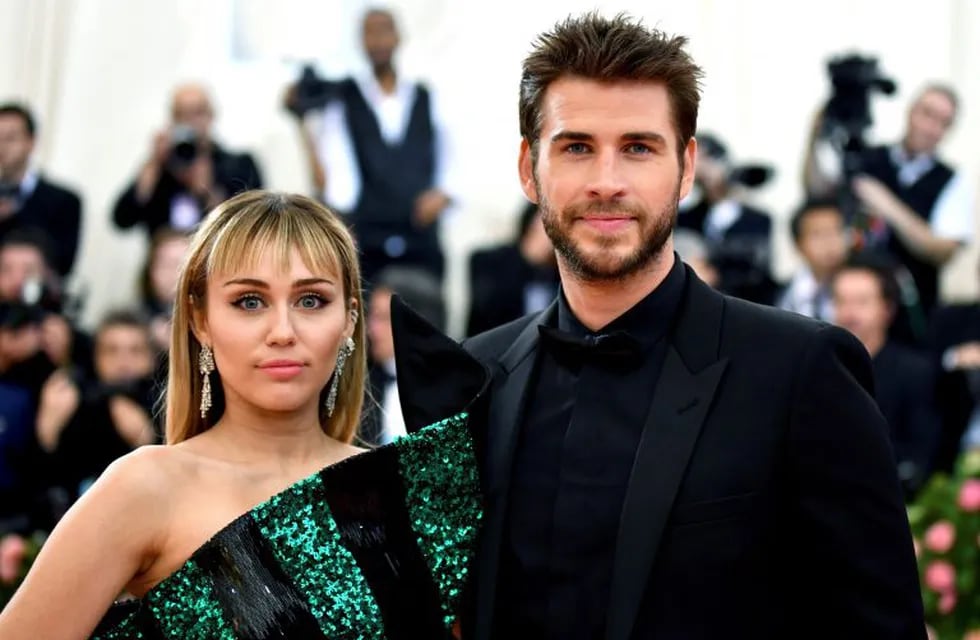 FILE - In this May 6, 2019 file photo, Miley Cyrus, left, and Liam Hemsworth attend The Metropolitan Museum of Art's Costume Institute benefit gala celebrating the opening of the \