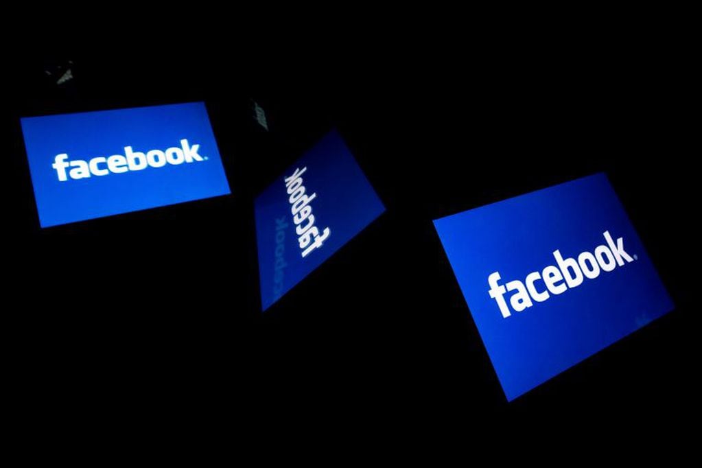 (FILES) In this file photo illustration taken on February 17, 2019, the US social media Facebook logo displayed on a tablet in Paris. - Facebook has fallen woefully short in stopping political manipulation of the platform by governments around the world, according to a data scientist fired this month by the social network. A scathing memo written by Sophie Zhang on her last day at Facebook, obtained by BuzzFeed News, claimed the California giant ignored or was slow to act on fake accounts used to undermine elections and political affairs in numerous countries. (Photo by Lionel BONAVENTURE / AFP)