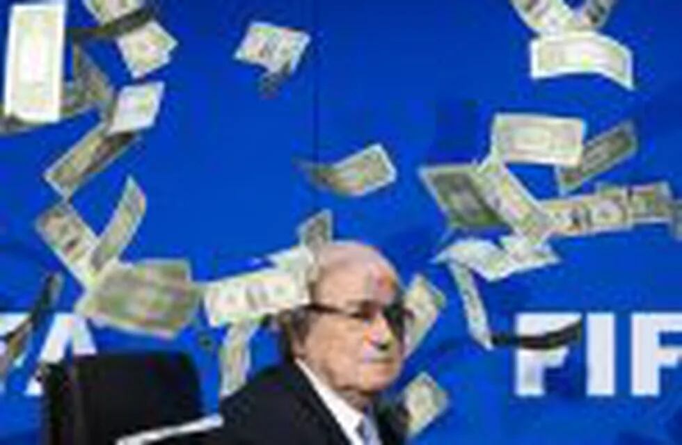 (FILES) This file photo taken on July 20, 2015 at the FIFA world-body headquarter's in Zurich shows FIFA president Sepp Blatter looking on as fake dollar notes fly around him, thrown by a British comedian during a press conference. nThe Court of Arbitrati