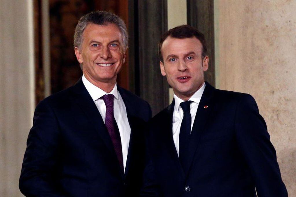 France President Emmanuel Macron, right, welcomes President of Argentina Mauricio Macri prior to a meeting, at the Elysee Palace, in Paris, Friday, Jan. 26, 2018. (AP Photo/Thibault Camus)