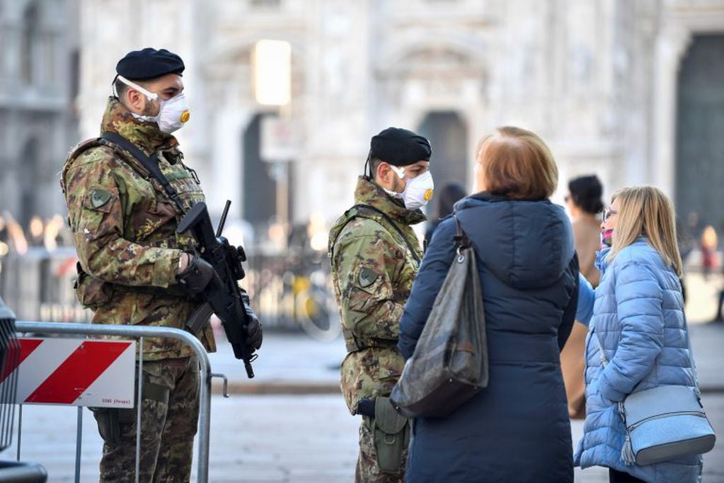Italian soldiers wearing sanitary masks patrol Duomo square in downtown Milan, Italy, Monday, Feb. 24, 2020. At least 190 people in Italy’s north have tested positive for the COVID-19 virus and four people have died, including an 84-year-old man who died overnight in Bergamo, the Lombardy regional government reported. (Claudio Furlan/Lapresse via AP)