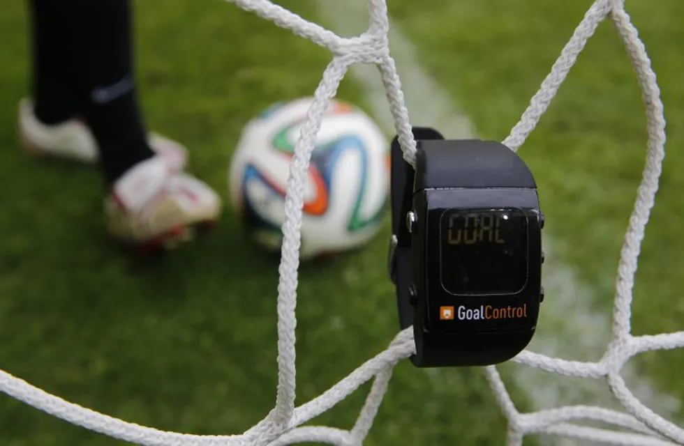 A GoalControl watch is displayed next to an official FIFA 2014 World Cup Brazil football during a demonstration of the goal-line technology in the western German city of Aachen May 28, 2014. German firm GoalControl has been appointed by FIFA as the official provider for the goal-line technology (GLT) at the upcoming soccer World Cup in Brazil. The watch will be worn by referees and will display the word 