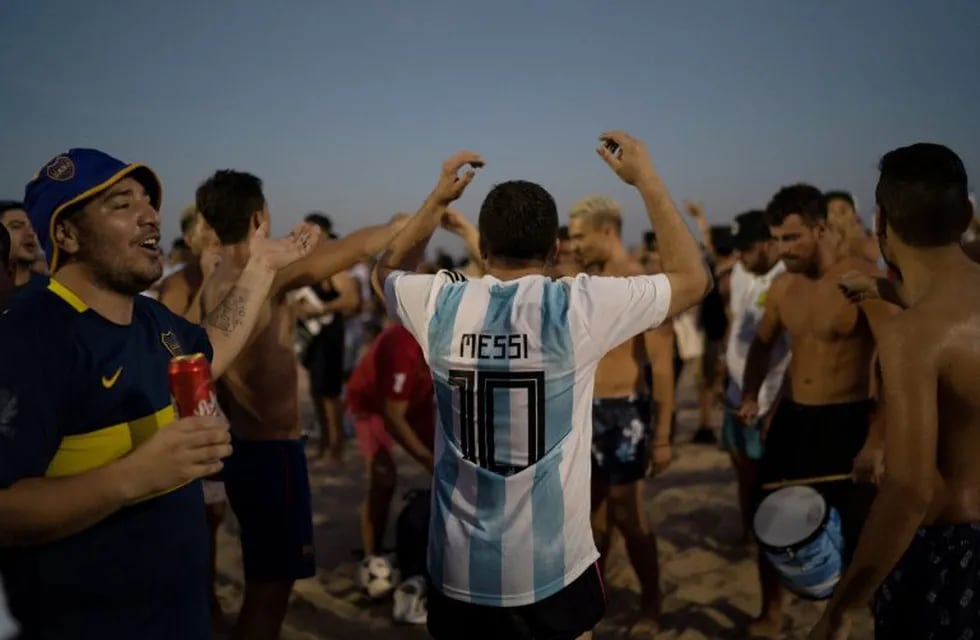 A man wears a jersey with the name of Argentina's soccer star Lionel Messi written on his back as the fans gather on Copacabana beach in Rio de Janeiro, Brazil, Monday, July 1, 2019. Argentina will play against Brazil for the semifinals of the Copa America on July 2. (AP Photo/Leo Correa)