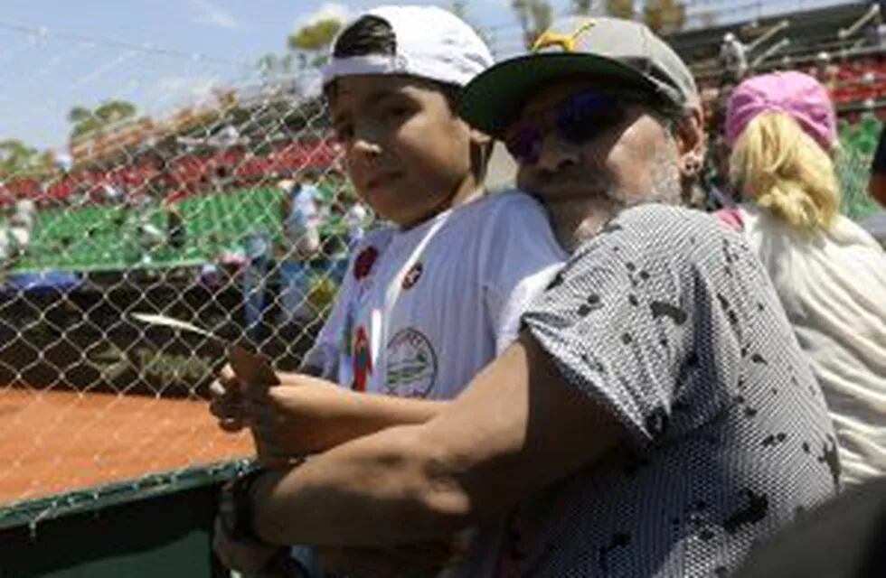 Argentina former footballer Diego Maradona poses with his grandson Benjamin Aguero (son of Gininna Maradona and footballer Sergio Aguero) after Italy's tennis player Paolo Lorenzi defeated by 6-3, 6-3, 6-3, Argentina's Guido Pella in their 2017 Davis Cup 