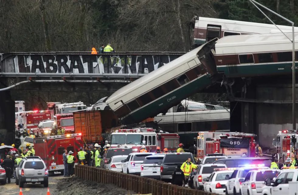 First responders are at the scene of an Amtrak passenger train which derailed and is hanging from a bridge over the interstate highway (I-5) in DuPont, Washington, U.S., December 18, 2017.    REUTERS/Nick Adams
