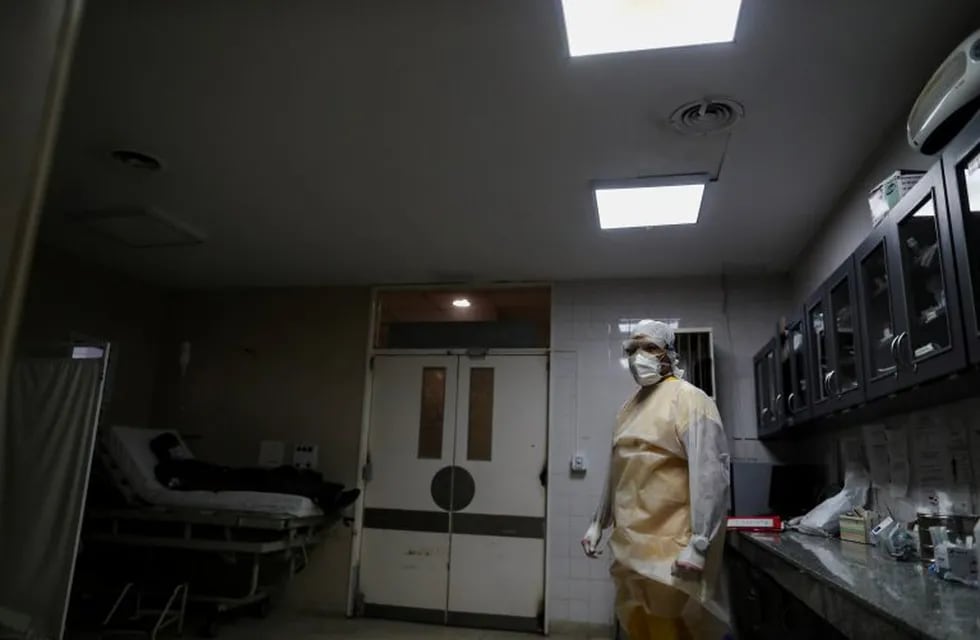 Dr. Matias Monteros stands in a shock room next to a patient infected with the coronavirus disease (COVID-19), at the Dr. Alberto Antranik Eurnekian hospital, in Ezeiza, on the outskirts of Buenos Aires, Argentina June 24, 2020. Picture taken June 24, 2020. REUTERS/Agustin Marcarian