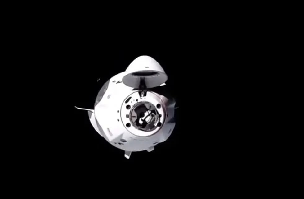 This NASA TV video grab shows Nasa's SpaceX Crew-1 mission aboard the SpaceX Crew Dragon as it approaches the International Space Station (out of frame) on November 16, 2020. - Four astronauts were successfully launched on the SpaceX Crew Dragon \