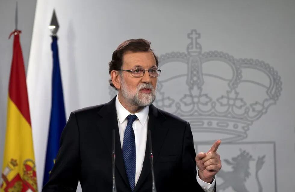 Spain's Prime Minister Mariano Rajoy speaks during a news conference at the Moncloa Palace in Madrid, Spain, Saturday, Oct. 21, 2017. The Spanish government moved to activate a previously untapped constitutional article Saturday so it can take control of Catalonia, illustrating its determination to derail the independence movement led by separatist politicians in the prosperous industrial region. (AP Photo/Paul White)