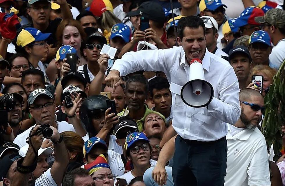 Venezuelan opposition leader and self-proclaimed acting president Juan Guaido speaks during a demo in Caracas on March 9, 2019. - Riot police blocked protesters as thousands of people took to the streets Saturday with tensions rising between opposition leader Juan Guaido and President Nicolas Maduro after crisis-wracked Venezuela emerged from the chaos of an electricity blackout. (Photo by Federico Parra / AFP)