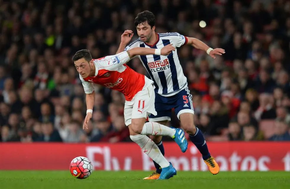Arsenal's German midfielder Mesut Ozil (L) turns away from West Bromwich Albion's Argentinian midfielder Claudio Yacob (R)  during the English Premier League football match between Arsenal and West Bromwich Albion at the Emirates Stadium in London on April 21, 2016.  RESTRICTED TO EDITORIAL USE. No use with unauthorized audio, video, data, fixture lists, club/league logos or 'live' services. Online in-match use limited to 75 images, no video emulation. No use in betting, games or single club/league/player publications. \r\n / AFP / GLYN KIRK                            / RESTRICTED TO EDITORIAL USE. No use with unauthorized audio, video, data, fixture lists, club/league logos or 'live' services. Online in-match use limited to 75 images, no video emulation. No use in betting, games or single club/league/player publications. \r\n inglaterra londres Mesut Ozil futbol liga primera division inglesa futbolistas partido arsenal vs Bromwich Albion