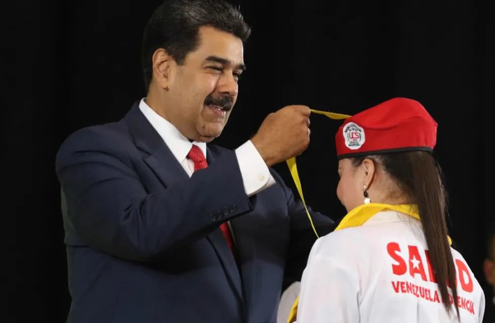 This handout photo released by Miraflores Presidential palace press office shows Venezuela's President Nicolas Maduro during the 8th Graduation of Integral Community doctors in Caracas, Venezuela on May 9, 2019. - Venezuela's opposition leader Juan Guaido accused President Nicolas Maduro's govermment on Thursday of \