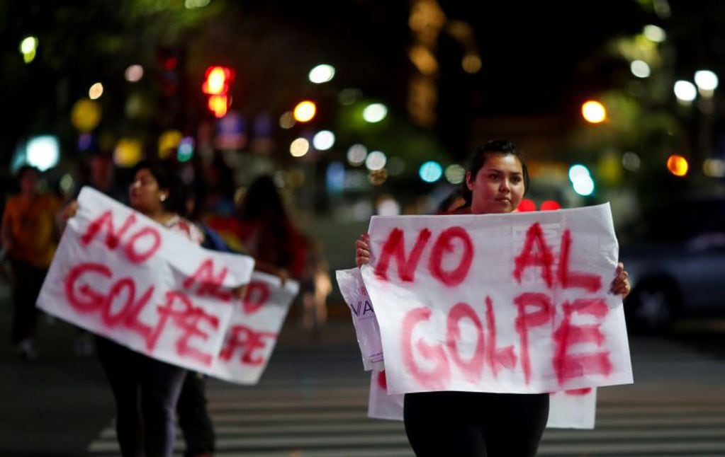 Bolivian residents in Argentina hold placards that reads "no to the coup", in support of Bolivian President Evo Morales, in Buenos Aires, Argentina November 10, 2019. REUTERS/Agustin Marcarian