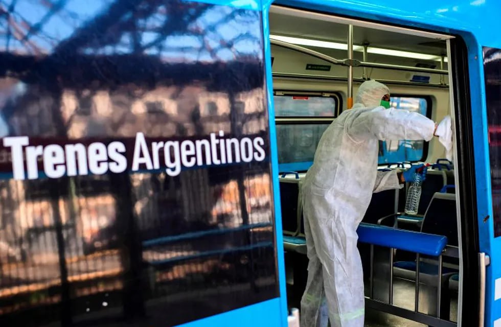 An employee of Trenes Argentinos disinfects and cleans a wagon at Constitucion train station, in Buenos Aires, on April 16, 2020 amid the COVID-19 coronavirus pandemic. (Photo by RONALDO SCHEMIDT / AFP)