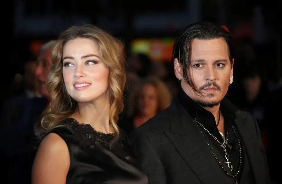 FILE - In this Oct. 11, 2015 file photo, Amber Heard, left, and Johnny Depp arrive at the premiere of Depp's film \