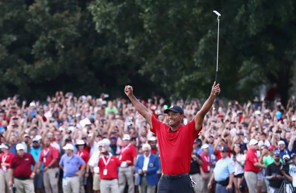 ATLANTA, GA - SEPTEMBER 23: Tiger Woods of the United States celebrates making a par on the 18th green to win the TOUR Championship at East Lake Golf Club on September 23, 2018 in Atlanta, Georgia.   Tim Bradbury/Getty Images/AFP\n== FOR NEWSPAPERS, INTERNET, TELCOS & TELEVISION USE ONLY ==