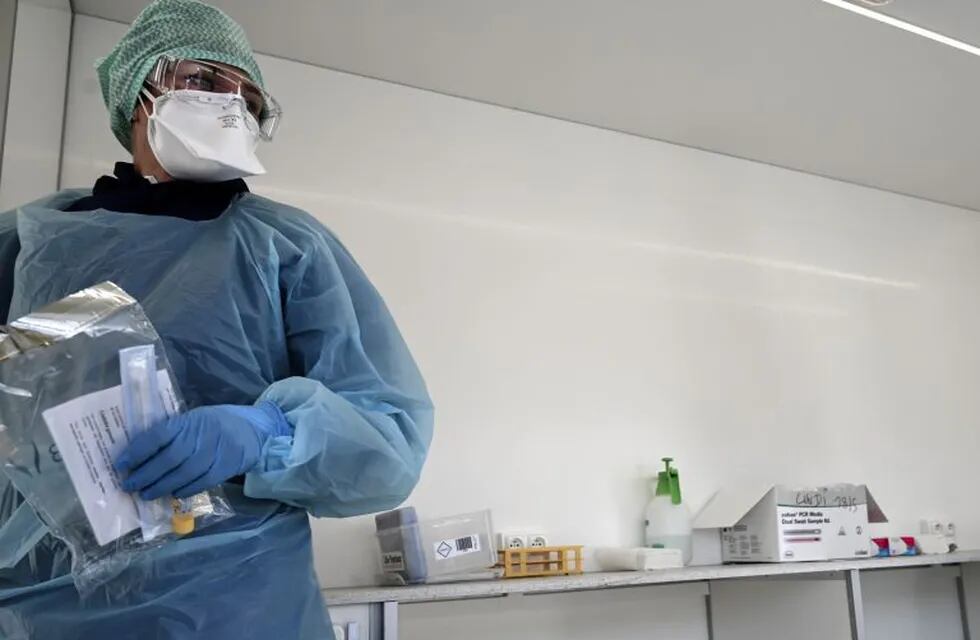 Biologists of the Synlab laboratory work at a COVID-19 coronavirus testing centre after collecting swab samples from employees of a company, in Lens, northern France, on May 18, 2020. (Photo by DENIS CHARLET / AFP)