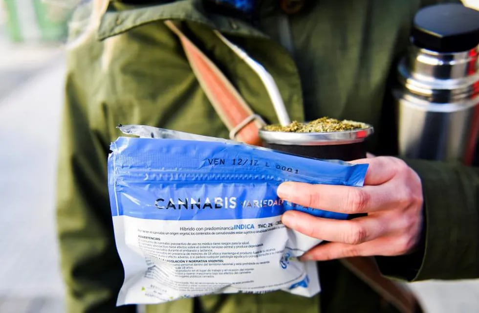 A woman holds her bag of legal marijuana and \