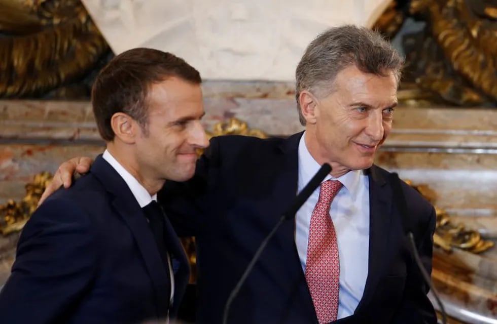 France's President Emmanuel Macron, left, and Argentina's President Mauricio Macri smile at the end of a joint press conference at the presidential palace in Buenos Aires, Argentina, Thursday, Nov. 29, 2018. Macron will attend the G20 two-day summit starting Friday. (AP Photo/Natacha Pisarenko)