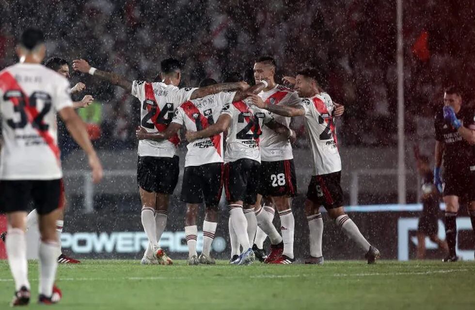 River Plate's footballers celebrate after defeating Banfield by 1-0 in their Argentina First Division 2020 Superliga Tournament football match at the Monumental stadium, in Buenos Aires, on February 16, 2020. - River Plate's players used jerseys with their names written in Chinese in solidarity with China due to the coronavirus epidemic in the framework of the celebrations of the Chinese New Year. (Photo by ALEJANDRO PAGNI / AFP)