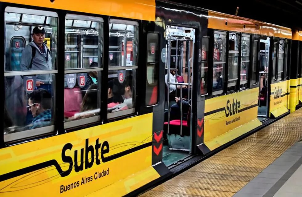 People ride on a subway train in Buenos Aires on October 23, 2019. - The state-owned Subterraneos de Buenos Aires (Sbase) filed a lawsuit against the Madrid Metro for the sale of carriages containing asbestos in 2011, a material associated with cancer, a company source confirmed AFP on Wednesday. (Photo by Ronaldo SCHEMIDT / AFP)