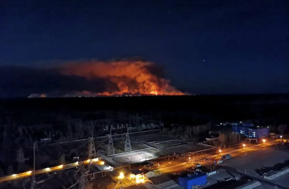In this photo taken from the roof of Ukraine's Chernobyl nuclear power plant late Friday April 10, 2020, a forest fire is seen burning near the plant inside the exclusion zone.  Ukrainian firefighters are labouring to put out two forest blazes in the area around the Chernobyl nuclear power station that was evacuated because of radioactive contamination after the 1986 explosion at the plant. (Ukrainian Police Press Office via AP)