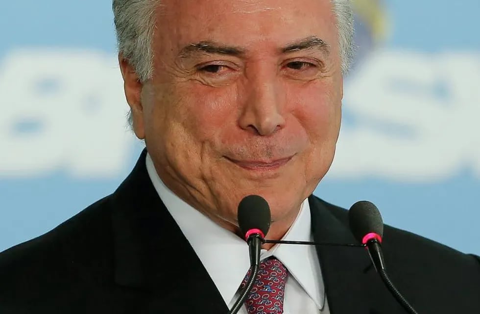 Brazil's President Michel Temer gestures during a ceremony to announce the airports' franchise programme, at the Planalto Palace in Brasilia, Brazil on July 27, 2017. \nBrazilian President Michel Temer's popularity fell from 10 percent in March to a meager 5 percent, according to a poll released on Thursday in the prelude to the voting at the Chamber of Deputies to decide if a corruption report against the conservative leader advances to the supreme court. / AFP PHOTO / Sergio LIMA