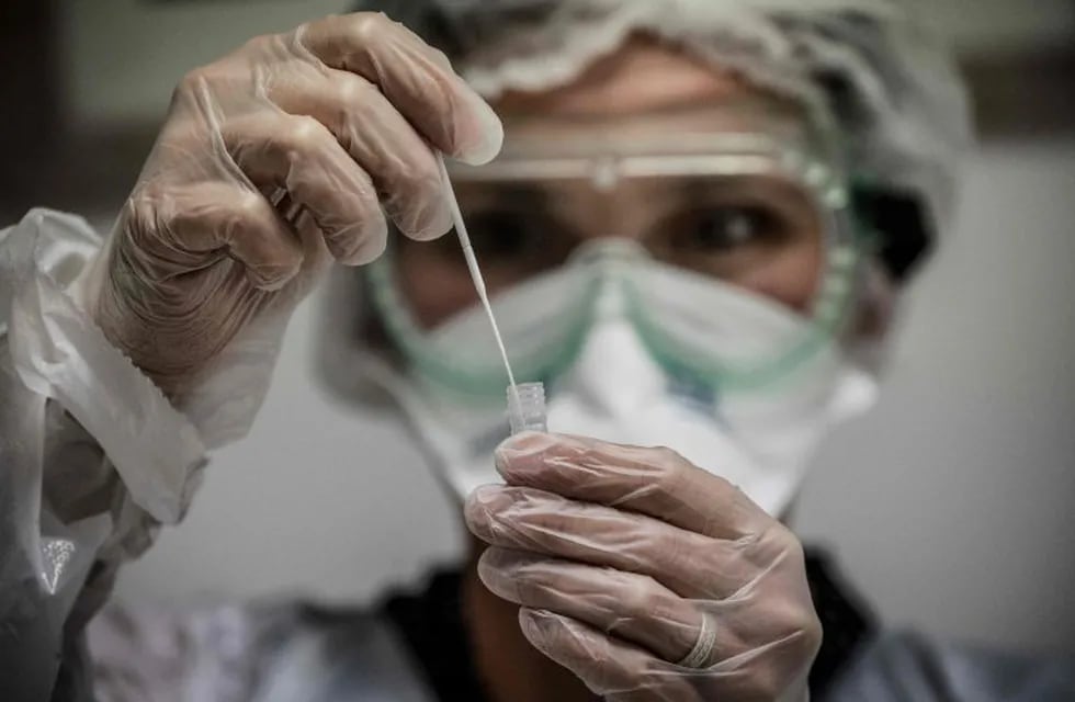 A medical assistant takes a sample from a patient for a coronavirus (Covid-19) test at an analysis laboratory in Le Peage-de-Roussillon, some 30kms south of Lyon, south-eastern France on September 22, 2020. (Photo by JEFF PACHOUD / AFP)
