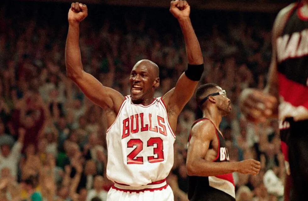 FILE - In this June 14, 1992, file photo, Michael Jordan celebrates the Bulls win over the Portland Trail Blazers in the NBA Finals in Chicago. Decades after Jordan's groundbreaking departure from college, March Madness and the NBA's mega-millions have taken all the novelty out of leaving early for the pros. (AP Photo/John Swart, File)