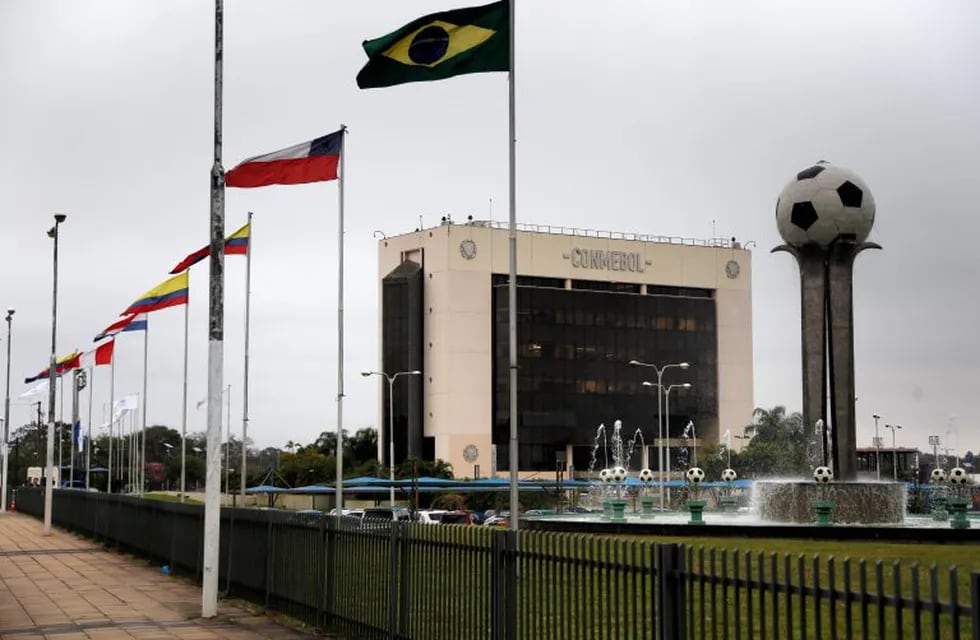 The flags of South America fly next to the South American soccer confederation, CONMEBOL, building in Luque, Paraguay, Tuesday, July 23, 2019. CONMEBOL has removed Argentine Football Association president Claudio Tapia from his seat on the FIFA council with immediate affect. Tapia was critical of the organisation in an open letter published during the Copa American earlier this month. (AP Photo/Jorge Saenz)