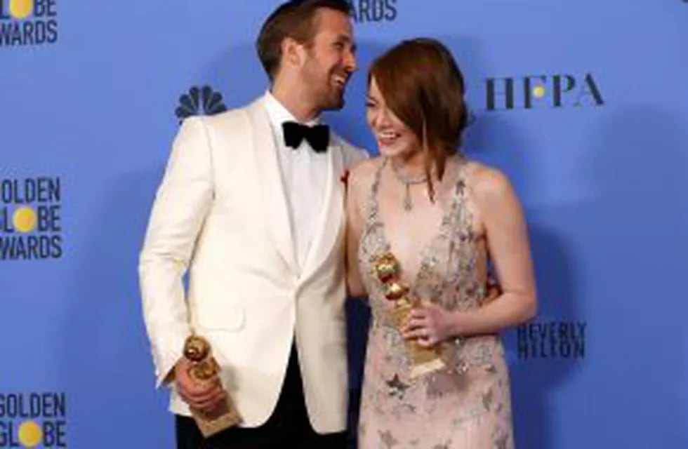 Ryan Gosling and Emma Stone pose with their awards for Best Performance by an Actor in a Motion Picture - Musical or Comedy and Best Performance by an Actress in a Motion Picture - Musical or Comedy for their roles in 
