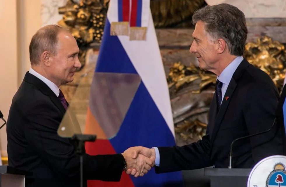 Argentina's President Mauricio Macri (R) and Russia's President Vladimir Putin shake hands after a joint press conference at the Casa Rosada presidential house in Buenos Aires, in the sidelines of the G20 Leaders' Summit on December 01, 2018. - The leaders of countries G20 leaders on Saturday found the minimum common ground on the global economy at a summit in Buenos Aires with a closing communique that left divisions on clear display. (Photo by Alberto RAGGIO / AFP)