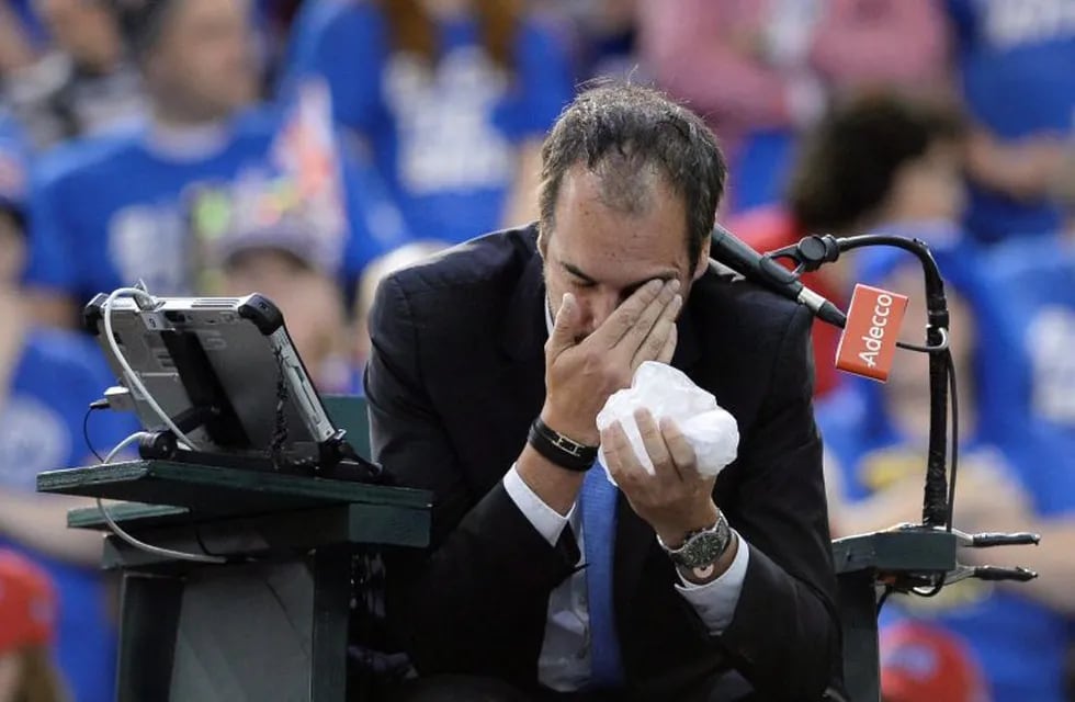 Umpire Arnaud Gabas, of France, holds his face after being hit by a ball during first-round Davis Cup tennis match action between Canada's Denis Shapovalov and Britain's Kyle Edmund, Sunday, Feb. 5, 2017, in Ottawa, Ontario. (Justin Tang/The Canadian Pres