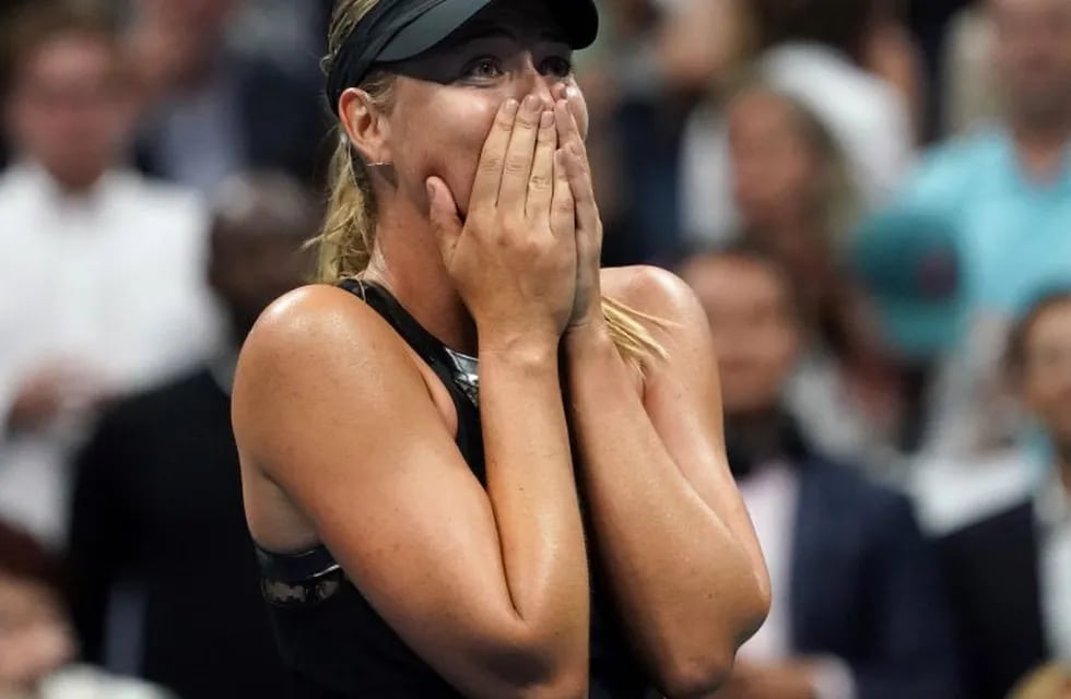 TOPSHOT - Maria Sharapova of Russia celebrates her victory over Simona Halep of Romania during their Women's Singles match at the 2017 US Open Tennis Tournament August 28, 2017 in New York. \nSharapova marked her first Grand Slam appearance since her doping ban ended with a 6-4, 4-6, 6-3 victory over second seed Halep.  / AFP PHOTO / DON EMMERT