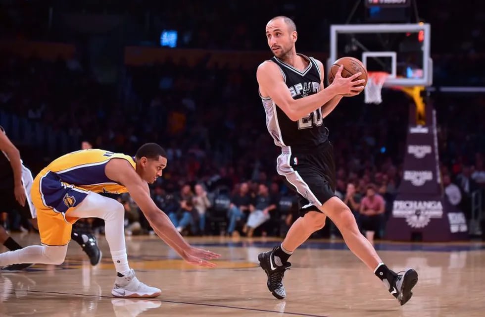 (FILES) This file photo taken on November 18, 2016 shows Manu Ginobili as he looks to pass getting away from Jordan Clarkson of the Los Angeles Lakers in Los Angeles, California during the NBA basketball matchup. \nSan Antonio Spurs legend Manu Ginobili is poised to return for a 16th season with the NBA giants, reports said July 18, 2017. The Argentine star, who turns 40 later this month, had hinted he may retire after the Spurs were downed in the Western Conference finals by Golden State last season.\n / AFP PHOTO / Frederic J. BROWN