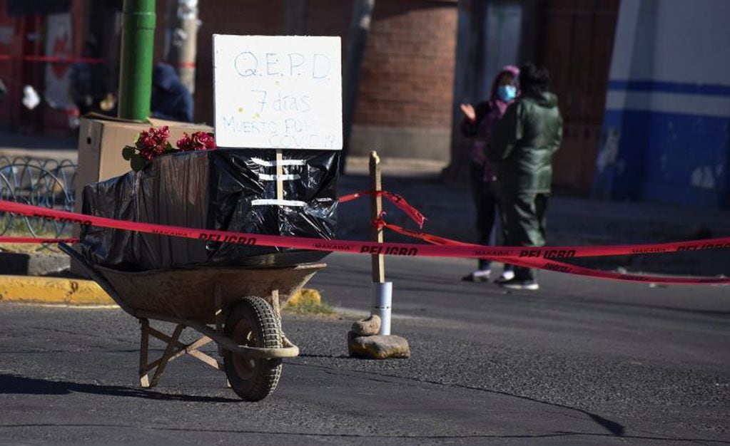 Familiares y vecinos bloquearon una calle con el ataúd de una persona fallecida con síntomas de coronavirus hace casi una semana, a fin de llamar la atención de las autoridades y para que el cuerpo sea enterrado. (AP Photo/Dico Soliz)