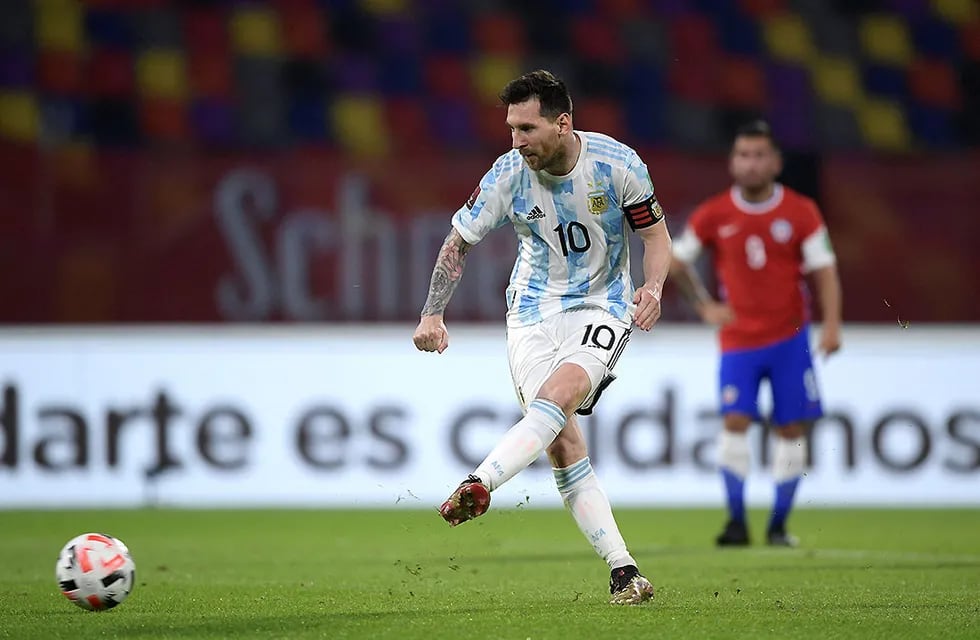 Argentina's Lionel Messi scores his side's opening goal on a penalty kick during a qualifying soccer match against Chile for the FIFA World Cup Qatar 2022 in Santiago del Estero, Argentina, Thursday, June 3, 2021.