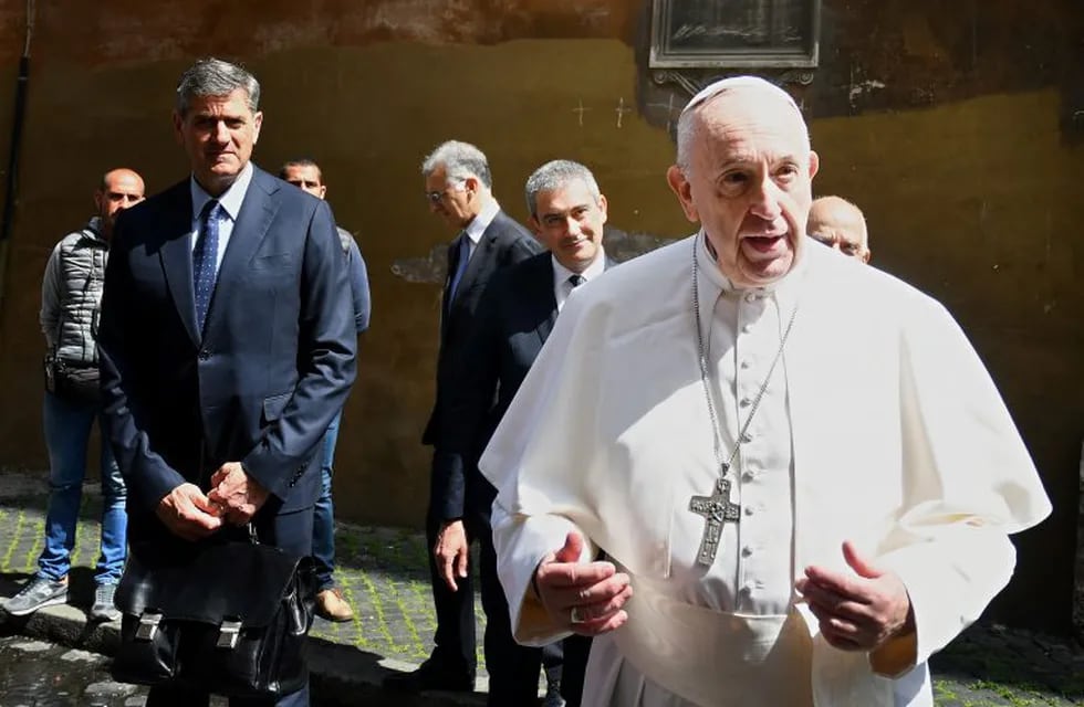 Pope Francis talks to the media as he leaves the Santo Spirito in Sassia church in Rome after he celebrated the Feast of Divine Mercy mass behind closed doors on April 19, 2020 during the country's lockdown aimed at stopping the spread of the COVID-19 (new coronavirus) pandemic. (Photo by Alberto PIZZOLI / AFP)