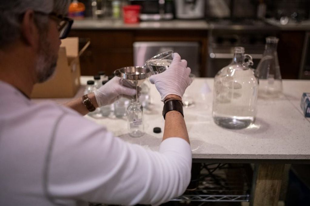 A worker fills a bottle with hand sanitizer solution made from distilled alcohol byproducts at the Glass Distillery in the SoDo neighborhood of Seattle, Washington, U.S., on Wednesday, March 18, 2020. The Glass Distillery is making their own hand sanitizer and offering it to their customers for free amid the coronavirus pandemic. Photographer: Chona Kasinger/Bloomberg