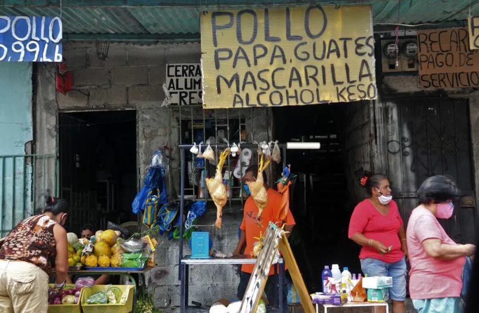 Products against the spread of the novel coronavirus, COVID-19, including gloves, face masks and sanitizing gel are being sold among food and other everyday products at a stand in Guayaquil, Ecuador, on May 4, 2020. - The novel coronavirus has killed at least 249,372 people worldwide since the outbreak first emerged in China last December, according to a tally from official sources compiled by AFP at 1900 GMT on Monday. (Photo by JOSE SANCHEZ / AFP)
