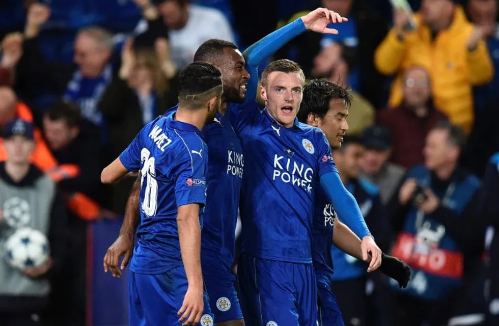 Leicester City's English-born Jamaican defender Wes Morgan (2L) celebrates scoring the opening goal with Leicester City's Algerian midfielder Riyad Mahrez (L), Leicester City's English striker Jamie Vardy (2R) and Leicester City's Japanese striker Shinji 