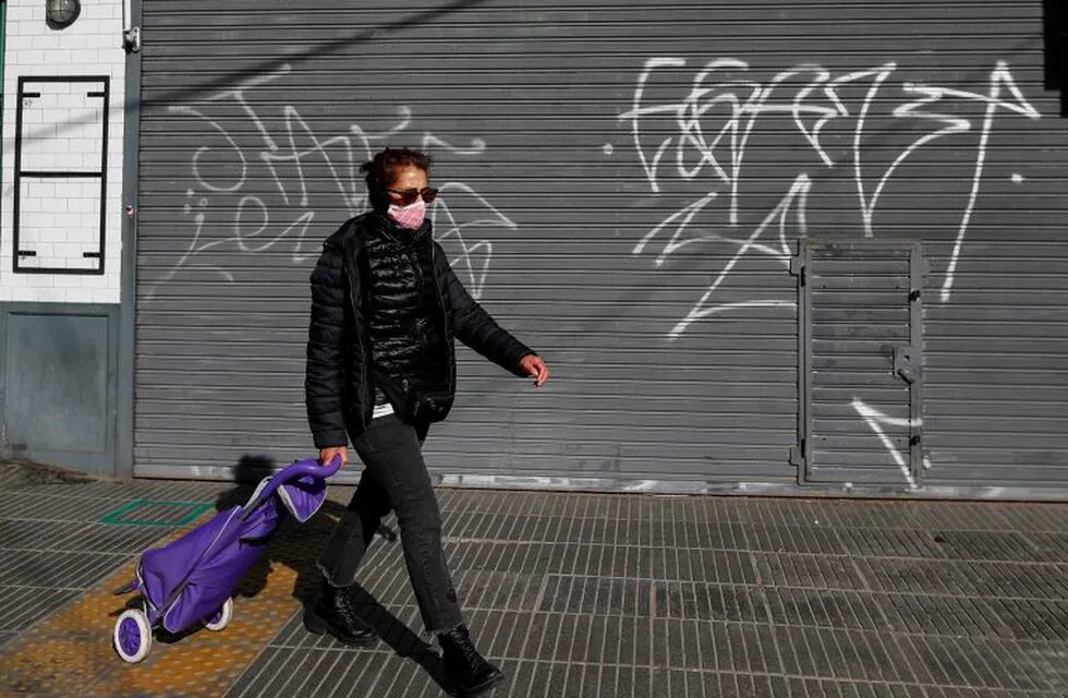 A woman wearing a face mask walks as the outbreak of the coronavirus disease (COVID-19) continues, in Buenos Aires, Argentina June 29, 2020. REUTERS/Agustin Marcarian