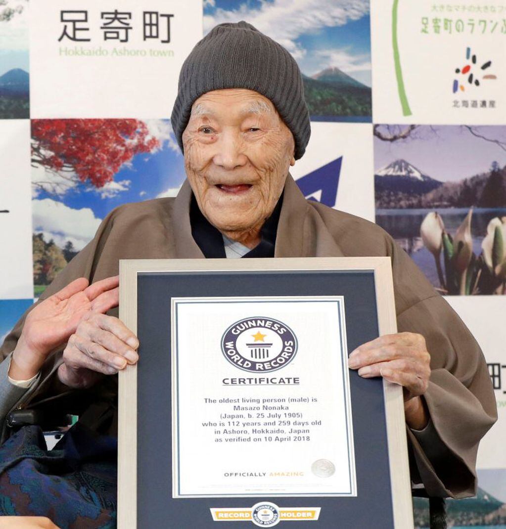 Masazo Nonaka con su certificado por ser el hombre más viejo del mundo cuando tenía 112 años. (AFP)