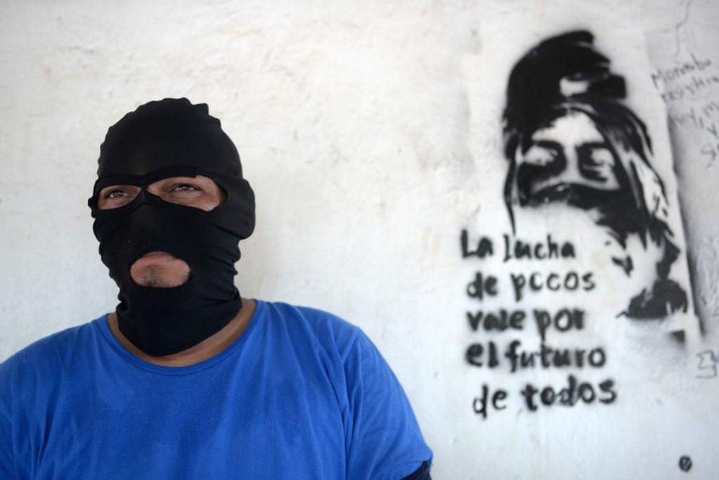 Paramilitar posando junto a un graffiti en Monimbo (Web)