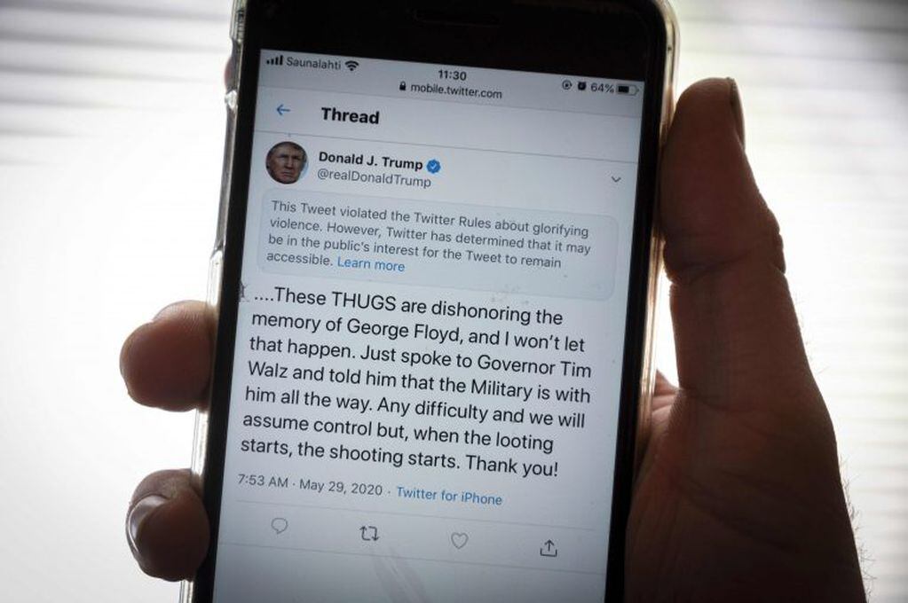 The twitter page of US President Donald Trump's is displayed on a mobile phone in Vaasa, Finland, on May 29, 2020. - Twitter on May 29, 2020 flagged a post by US President Donald Trump on the unrest in Minneapolis as 'glorifying violence', saying the tweet violated its rules but would not be removed. (Photo by Olivier MORIN / AFP)