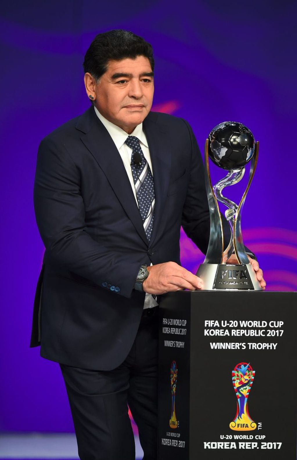 Argentinian football star Diego Maradona puts the trophy on the table during the official draw for the FIFA under-20 football World Cup in Suwon, south of Seoul, on March 15, 2017.
The FIFA U-20 World Cup will be held in South Korea from May 20 to June 11