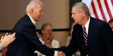 Democratic 2020 U.S. presidential candidate and former Vice President Joe Biden shakes hands with former Iowa Governor Tom Vilsack during a campaign event in Newton