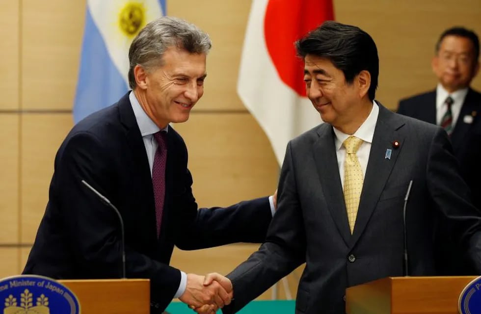 Argentinian President Mauricio Macri, left, shakes hands with Japan's Prime Minister Shinzo Abe during their joint press conference at Abe's official residence in Tokyo Friday, May 19, 2017. (Toru Hanai/Pool Photo via AP)
